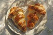 Freshly Baked Delight: Two Croissants Embracing the Warmth of a French Eatery