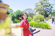 © photok - 公園で微笑む赤いドレスを着た日本人女性