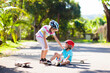 © famveldman - Kids with skate board. Skateboard fall and injury.
