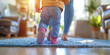 A image of a baby taking their first steps with support from a parent or caregiver, capturing the milestone moment of learning to walk