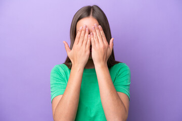 Wall Mural - Young caucasian woman isolated on purple background covering eyes by hands