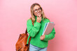 Young student woman isolated on pink background looking up while smiling