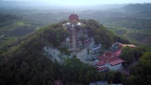 An Amazing Landmark In Thailand Known As Wat Pa Phu Hai Long In Pak Chong, Nakhon Ratchasima. A Sunset Drone Shot Over Looking The Temple, Valleys, Rice Fields And Mountain Ranges In This Quiet Region
