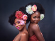 © peopleimages.com - African, beauty and friends with flowers in makeup and art in dark background, studio and mockup. Floral, cosmetics and black woman in portrait with creativity in spring or sustainable skincare