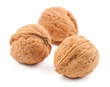 Three whole walnuts, detailed texture, white background isolated