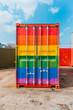 A large container with rainbow colors painted on it