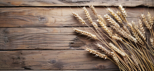 Wall Mural - Organic wheat ears on the wooden background with space for text