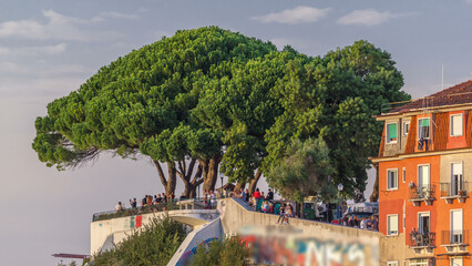 Wall Mural - Tourists at Belvedere of Our Lady of the Hill viewpoint, looking at the cityscape of Lisbon at sunset timelapse.