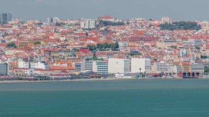 Wall Mural - Panorama of Lisbon historical centre aerial timelapse viewed from above the southern margin of the Tagus or Tejo River.