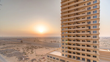 Wall Mural - Sunset in Ajman aerial view from rooftop timelapse. United Arab Emirates.