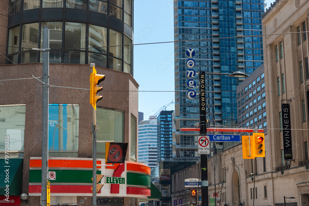 general view of Yonge street at Carlton with sign of 7-Eleven, a ...