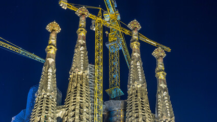 Wall Mural - Sagrada Familia, a large church in Barcelona, Spain night timelapse.