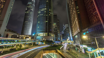 Wall Mural - Hong Kong Business District with busy traffic timelapse at night.