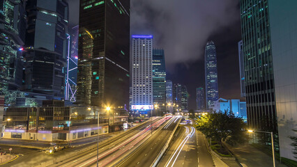 Wall Mural - Hong Kong Business District with busy traffic timelapse at night.