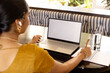© Wavebreak Media - Indian young woman typing on laptop at home, notebook and pen beside her, copy space