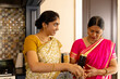 © Wavebreak Media - Indian mother and teenage daughter cooking together at home in kitchen