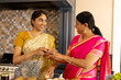 © Wavebreak Media - Indian mother and teenage daughter, wearing traditional clothes, cooking at home