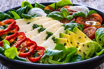 Poster - Fresh vegetable salad with robiola cheese and avocado on wooden table
