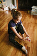 6 year old girl pulling on socks
