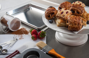 Wall Mural - Freshly baked pastries amid baking tools and ingredients