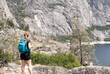 Hiker contemplates the grandeur of Hetch Hetchy, Yosemite