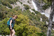 Hiker immersed in wilderness near Hetch Hetchy waterfall, immers