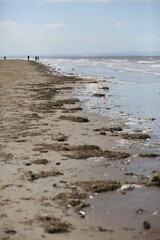 Sticker - Sandy beach with ocean views and people strolling