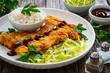 Tonkatsu - crispy Japanese pork chop with white rice and fresh vegetables on wooden table
