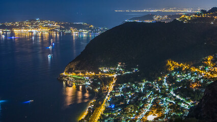 Wall Mural - Night timelapse view of the Mediterranean coastline of the town of Eze village on the French Riviera