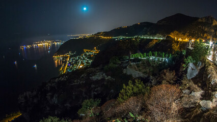 Wall Mural - Night timelapse view of the Mediterranean coastline of the town of Eze village on the French Riviera