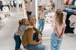 Father Trying on Clothes With Daughters at a Clothing Store During Shopping Day