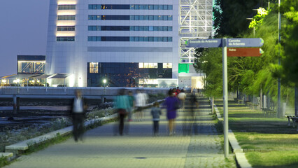 Wall Mural - Walkway near Hotel Tower in the Park of the Nations timelapse from day to night