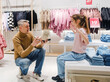 Father and Daughter Trying on Shoes Together at a Retail Store