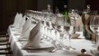 A meticulously set dining table, possibly in a fine dining restaurant or a banquet hall. The table is adorned with multiple wine glasses, neatly aligned in a row.