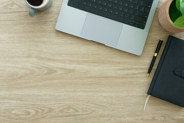 Wall Mural - Modern workplace with laptop computer, coffee cup and pencils on wooden background. Top view.