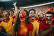 Crowd from Spain celebrating victory in a stadium, with faces painted red and yellow in support of the team.