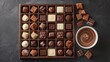 Chocolate candy box / Assortment of fine chocolates in white, dark, and milk chocolate and a bowl of melted chocolate