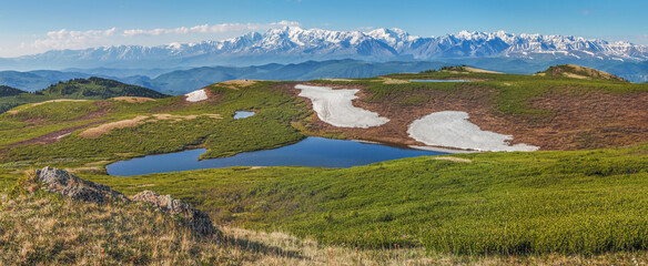 Wall Mural - Mountain landscape, small lake, snow on slopes and glaciers, panoramic view