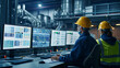 © Phakawan - Workers operating control panels and monitoring screens in a high-tech control room, showcasing the technological aspect of modern manufacturing.