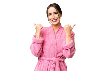 Wall Mural - Young beautiful woman in a bathrobe over isolated chroma key background with thumbs up gesture and smiling