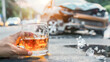 Glass of whiskey or cognac against the backdrop of an accident with a broken car. Concept of driving a car while drunk