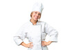 © luismolinero - Young chef woman over isolated chroma key background posing with arms at hip and smiling