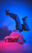 A man is doing a handstand on a blue background. Urban concept.