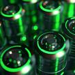 Futuristic green-lit batteries in close-up view.
