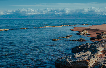 Poster - Rocky lake shore of Issyk-kul lake in Kyrgyzstan in spring