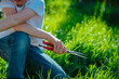 Boy with grass clippers cutting lawn on a sunny summer day