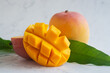 Ripe mango fruit and mango slice on marble background