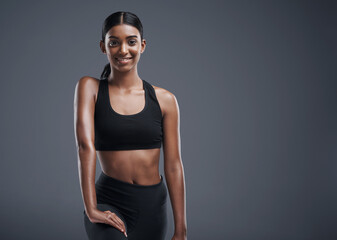 Wall Mural - Fitness, athlete and portrait of Indian woman in studio, background and happiness in mockup space. Gym, exercise and girl after workout with health, wellness and pride in training as body builder