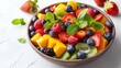 Mixed fruit salad in the bowl on white background. 