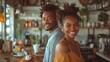 Young African couple pose smiling in a kitchen